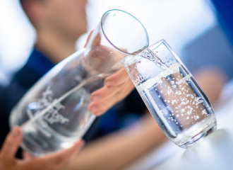 Image of water being poured into a glass