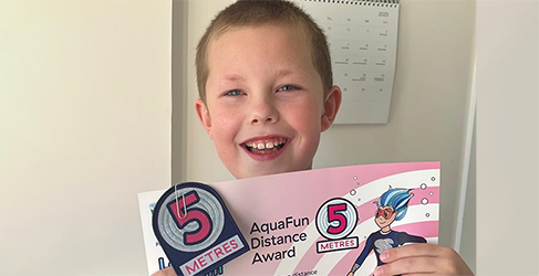 Learn to Swim Jack Clews Young Jack Clews with his latest swimming certificate from Learn to Swim
