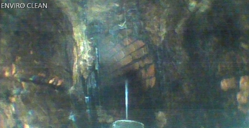 The sewer had become clogged with concrete-like calcite and other materials over many years UHP Robot