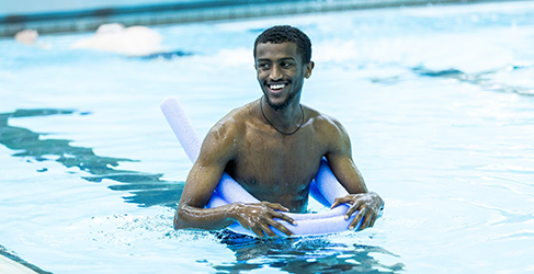 Learn to Swim Never Too Late Amanuel Akalu in the pool with Learn to Swim teacher Lucy McCluskey