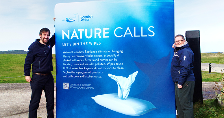 UK Wet Wipes ban Scottish Water regional manager Gavin Steel holding banner calling us to bin the wipes with our Nature Calls campaign