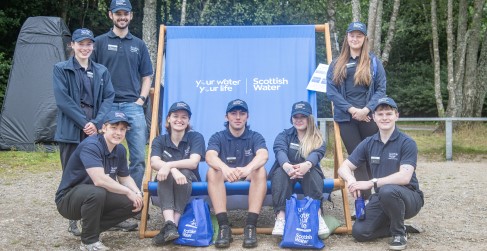 Scottish Water Employees Pose on Blue Branded Deck Chair Scottish Water Employees Pose on Blue Branded Deck Chair