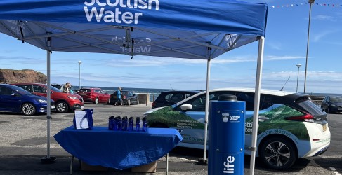 Set up of Top Up Tap launch including small gazebo, table offering reusable water bottles, and Scottish Water branded vehicle Set up of Top Up Tap launch including small gazebo, table offering reusable water bottles, and Scottish Water branded vehicle