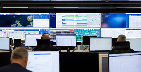 ICC Glasgow banks of digital screens in the control room at Scottish Water with some staff at their desks
