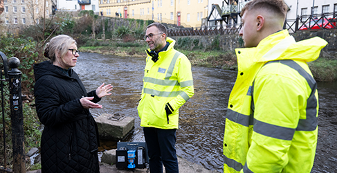 1000 EDM monitors launch Cabinet Secretary Gillian Martin, Professor Simon Parsons and Scottish Water operative Ethan Hermiston at Water of Leith in Stockbridge, Edinburgh